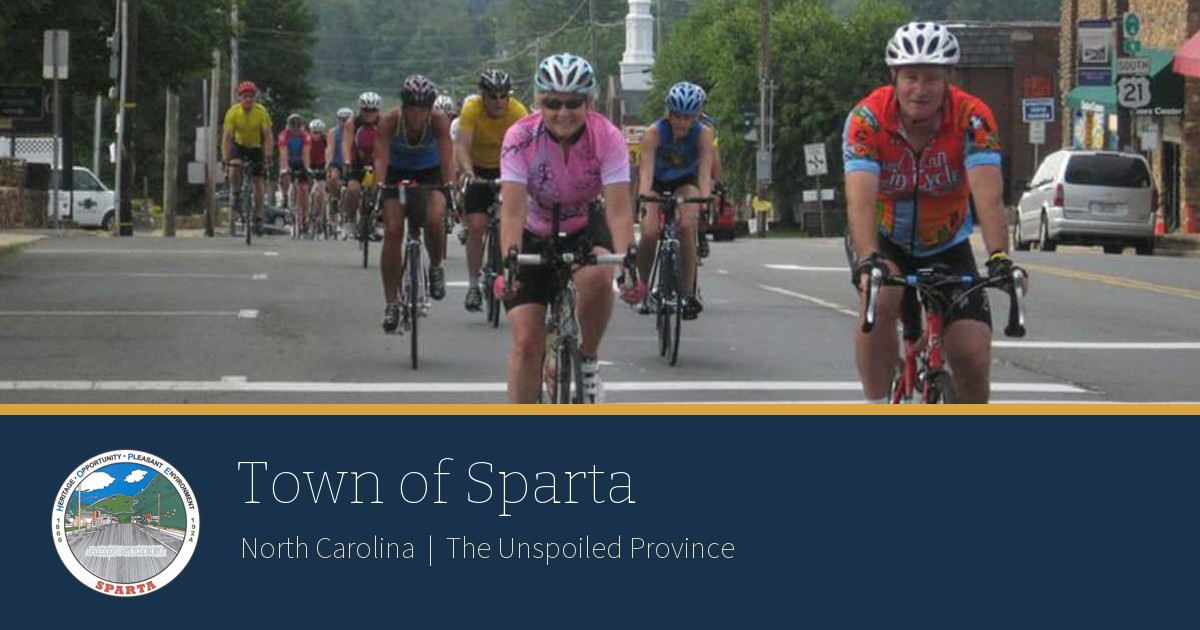 Town of Sparta, North Carolina: cyclists on Main Street above the Town seal